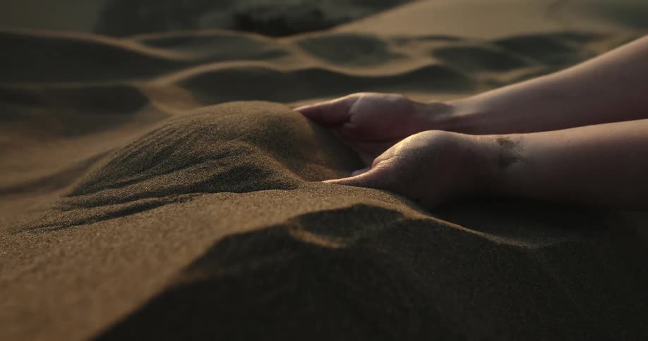 The view is of someone grabbing some sand on the beach