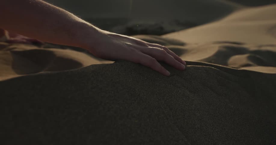 The view is of someone touching the sand at the beach
