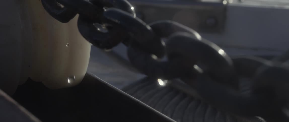 A large link chain with water droplets falling