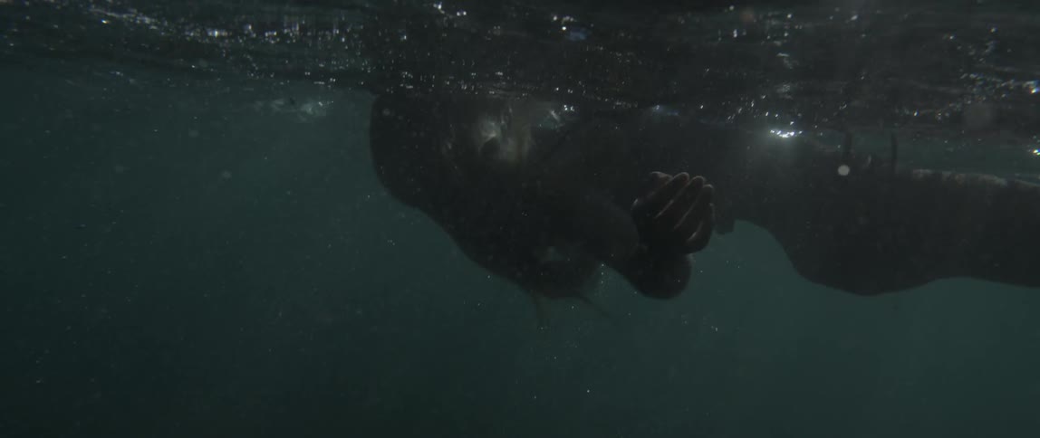 Woman floating on her back as seen just below water level