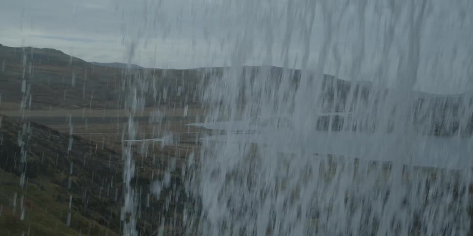 A waterfall crashing down with a river below