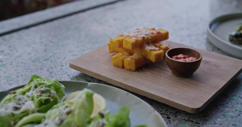 Several dishes served over a granite table at a restaurant