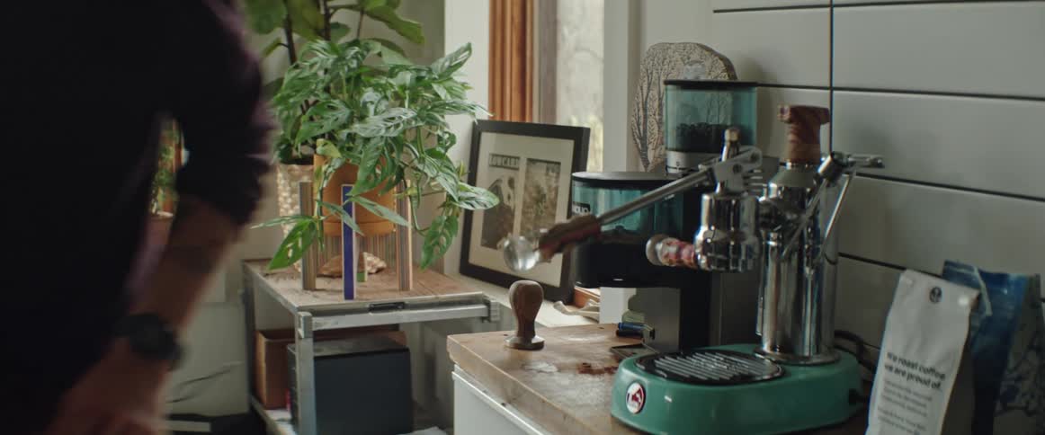 A man preparing a coffee beverage at home
