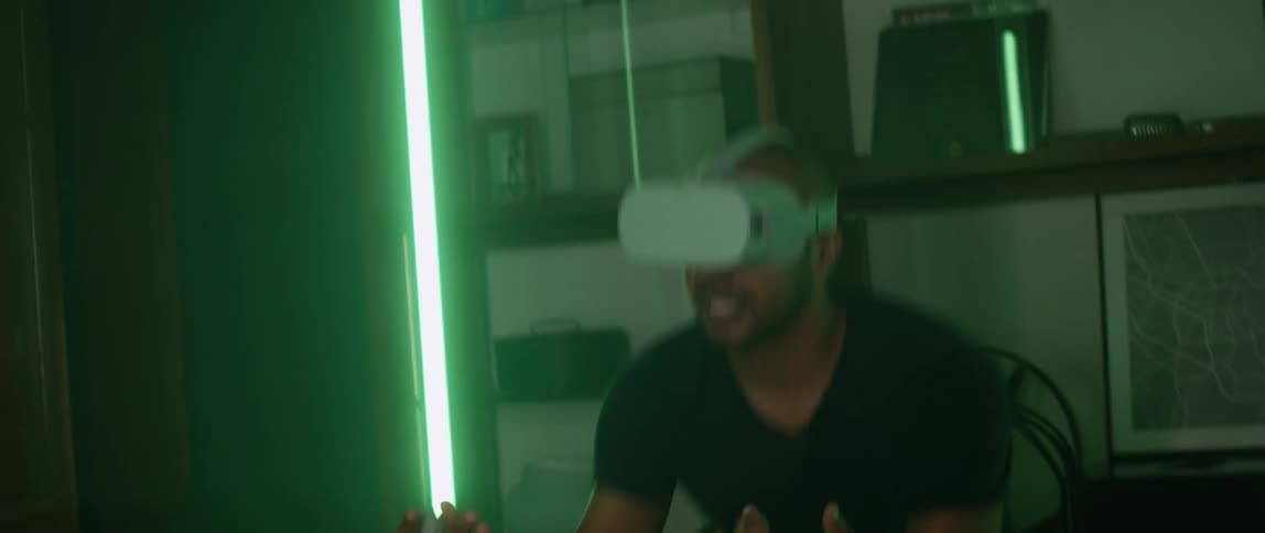 Man plays virtual sports game at home using vr goggles