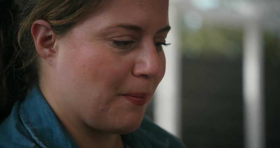 Woman engaged in a conversation with offcamera person seems to be in a discussion