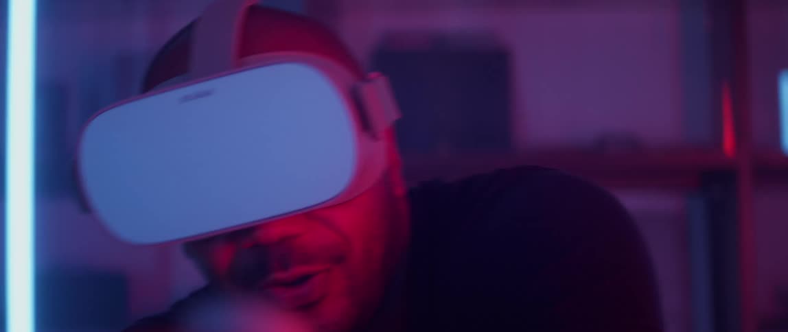 Man wearing black shirt and virtual reality headset plays video game