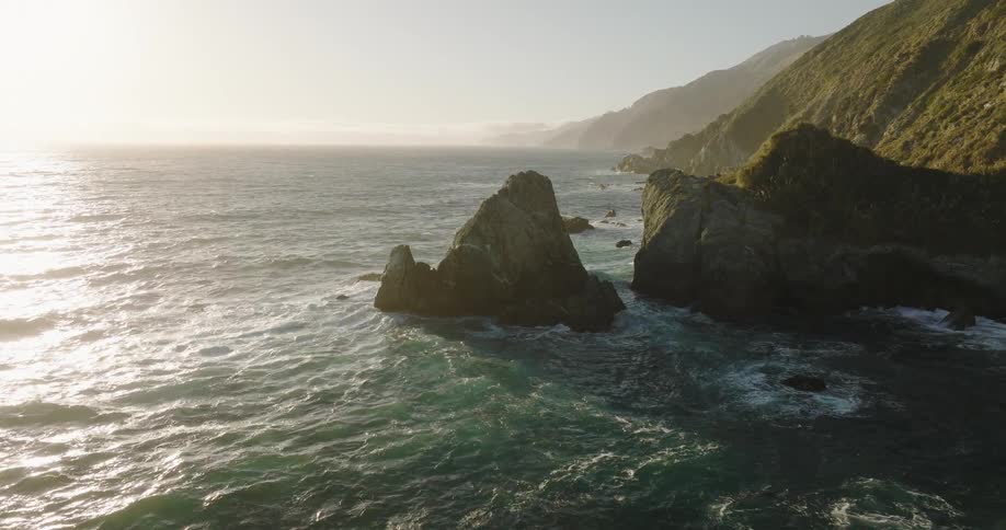 Waves crash onto rocks along the coast