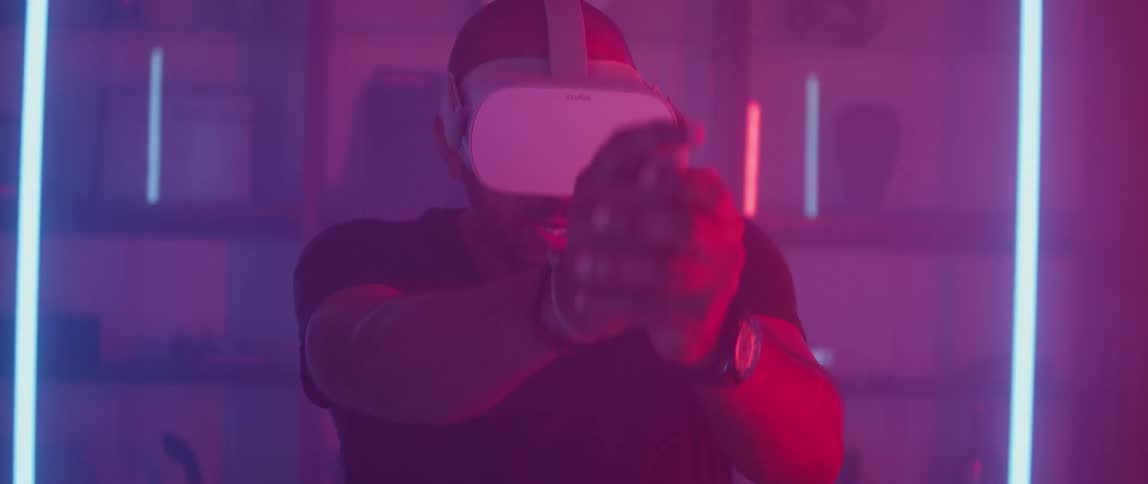 A man playing a shooter game with a virtual reality headset