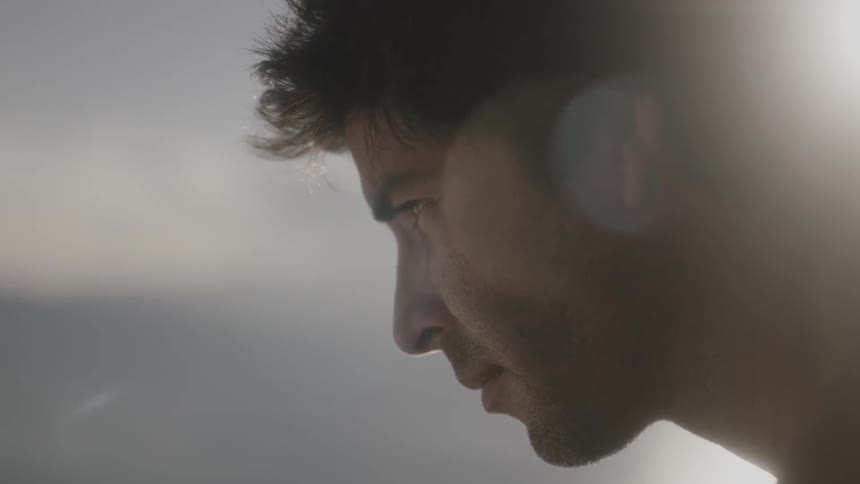 Close-up of a man's profile looking quietly forward at sunset