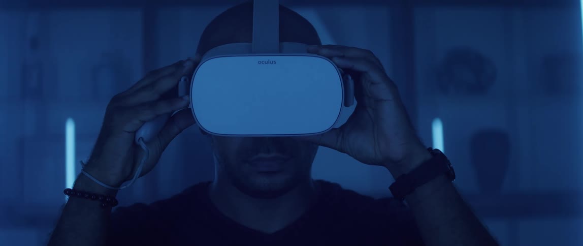 A man at home puts on a virtual reality headset