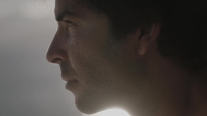 A man looks up slowly while contemplating