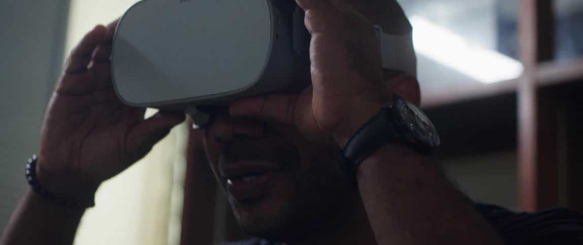 A man removes his virtual reality headset
