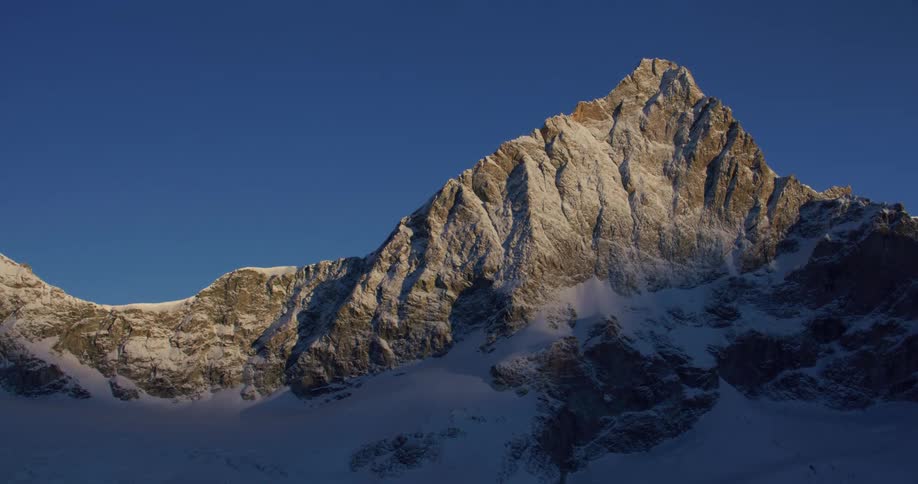 The tall mountain is in the shade