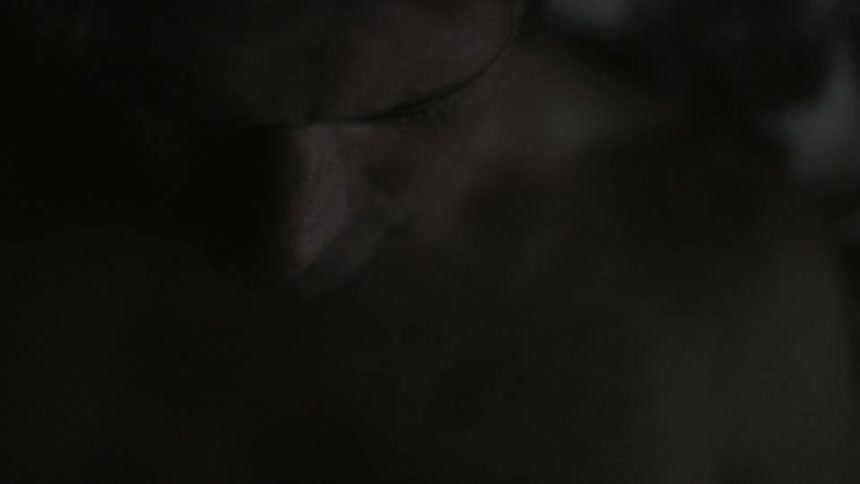A man stands in a dark room