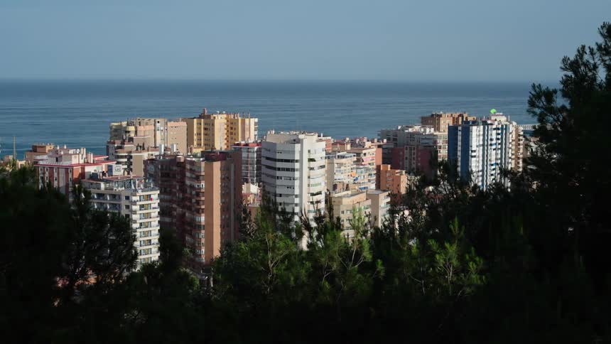 Buildings on a waterfront city close to the ocean at morning