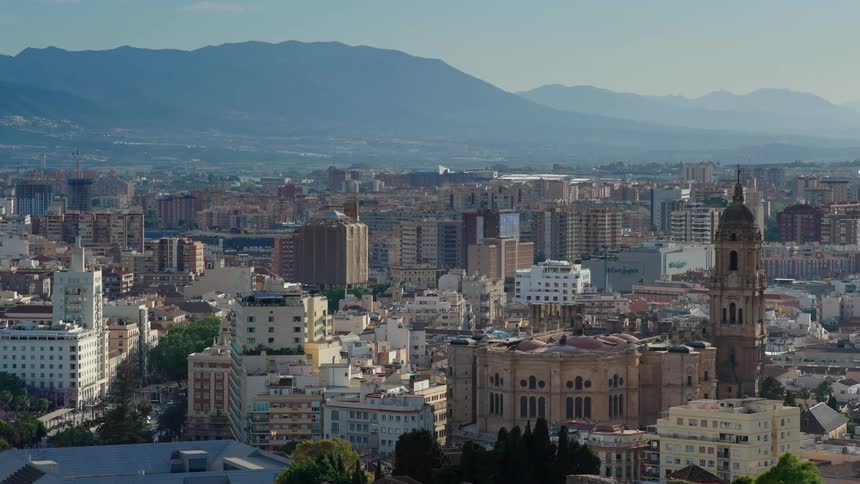 Aerial view of an old church towering over the city near a mountain at morning