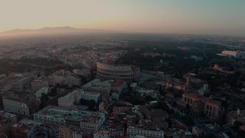 Orbiting aerial view of the coliseum in rome at evening