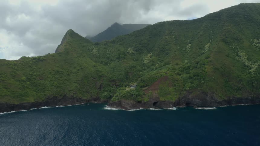 An aerial view of coastal mountains on a cloudy day
