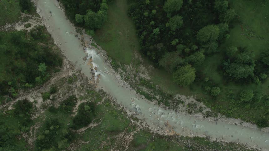 Aerial top down view of a river flowing through the countryside