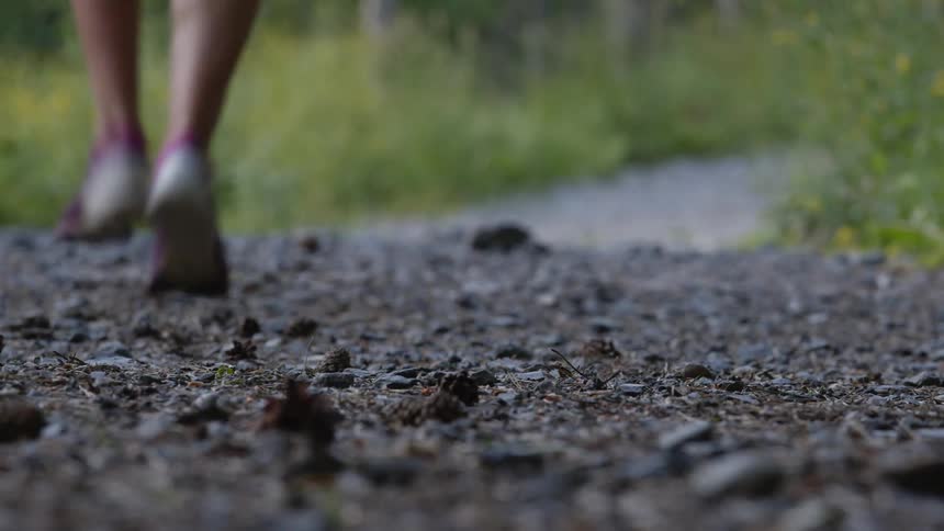 A person is jogging outdoors during the spring