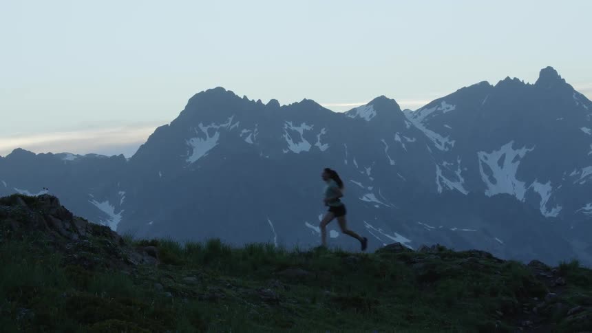 A woman running along a ridge