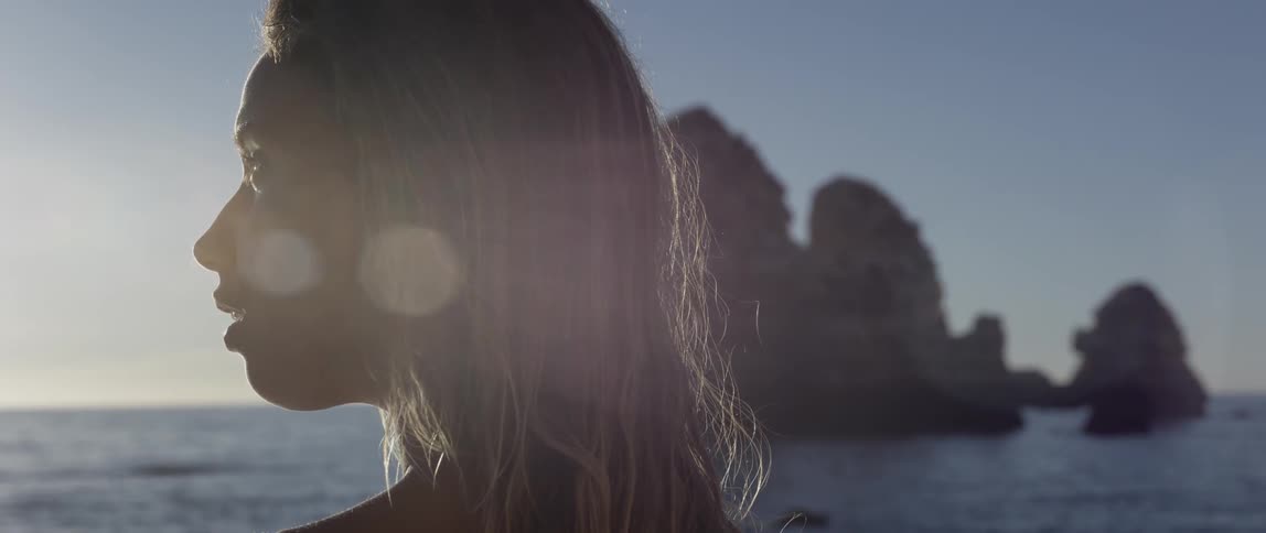 Blonde woman at a beach at sunset
