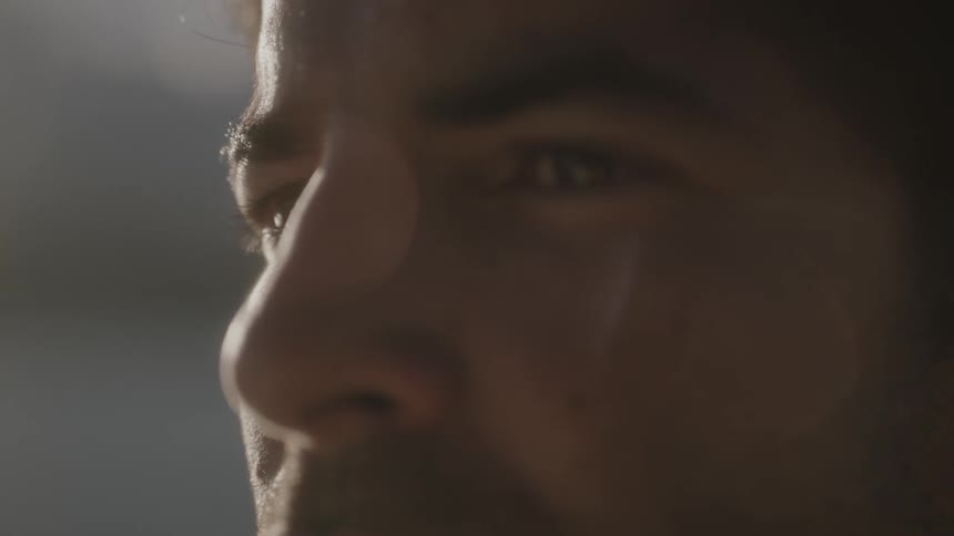 A man looks forward on a windy day