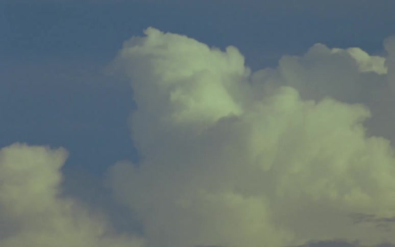 Thick white clouds in the sky on a sunny day