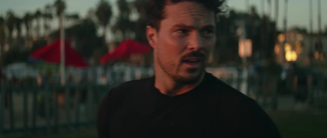 A man holding a soccer ball breathes heavily