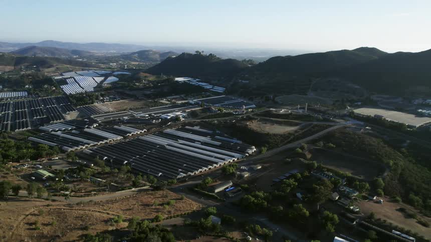 Many greenhouses occupy area near hills