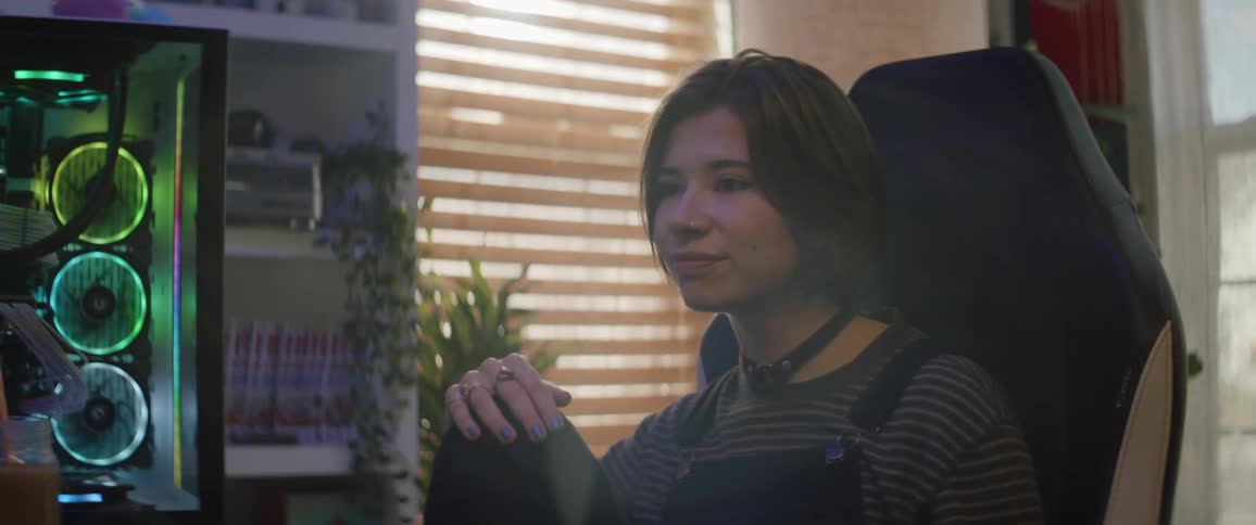A female is sitting in a chair talking and smiling