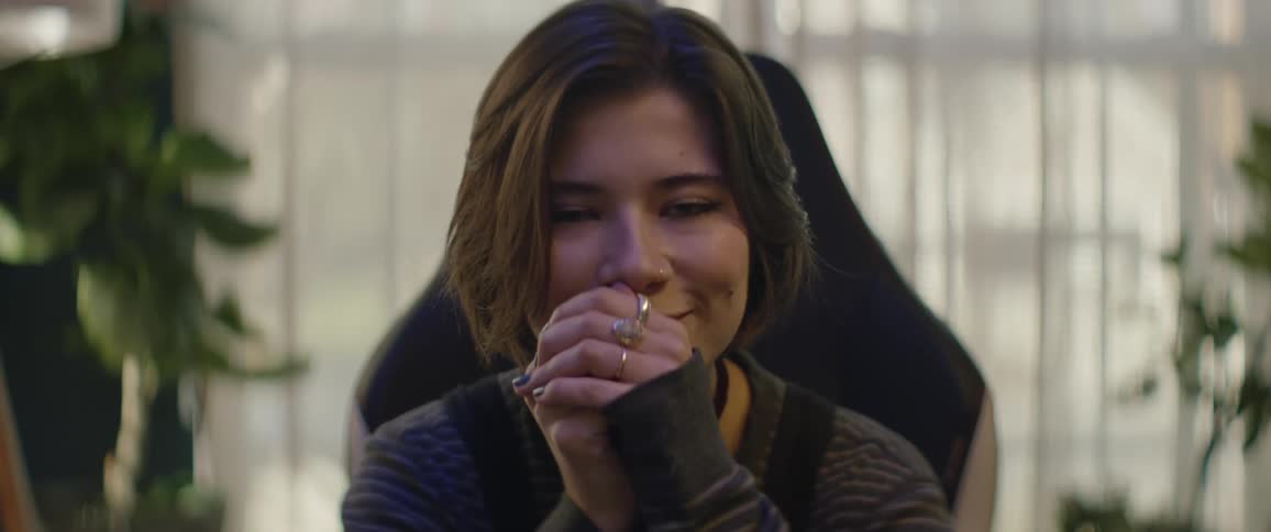 Woman types and smiles while working