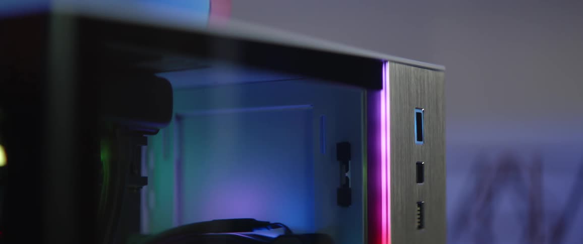 A person presses a button on the side of a computer case