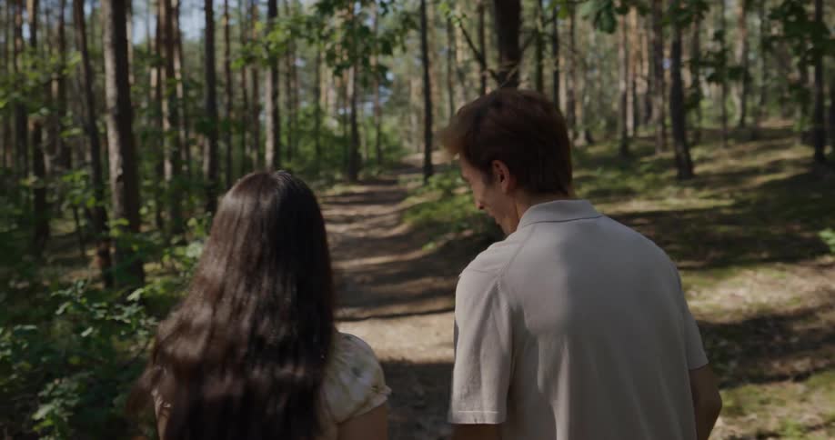 A couple walking on a path in the woods