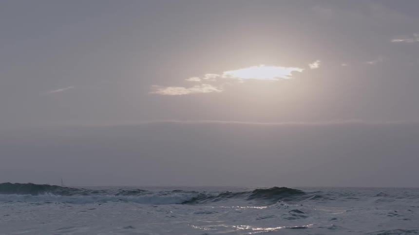 Waves coming ashore at sunset