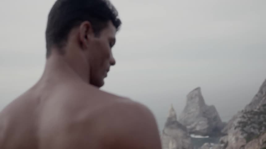 Man standing high above a beach