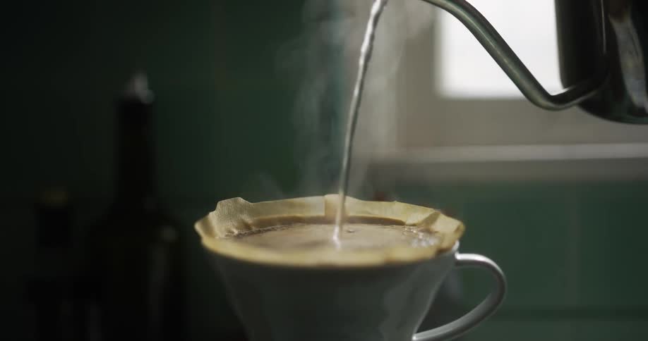 A person brewing coffee