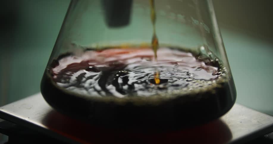 Coffee drips into a coffee pot on a pedestal