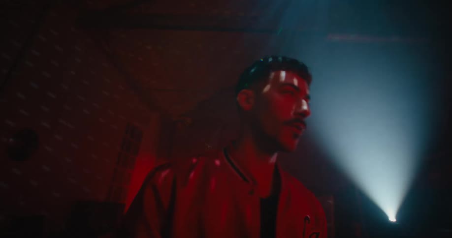 A man standing in a room with a disco ball