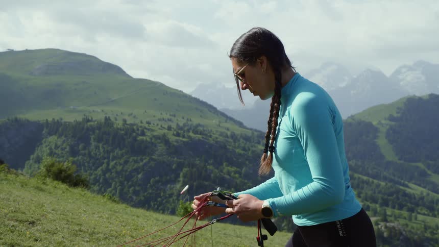 A woman preparing to paraglide
