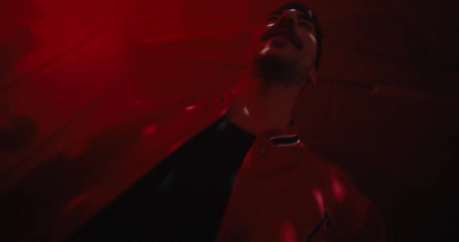 A man high fives a friend as he walks past people dancing in a night club