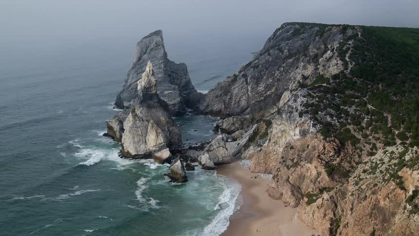 Aerial view of a beach with tall pointy rocks
