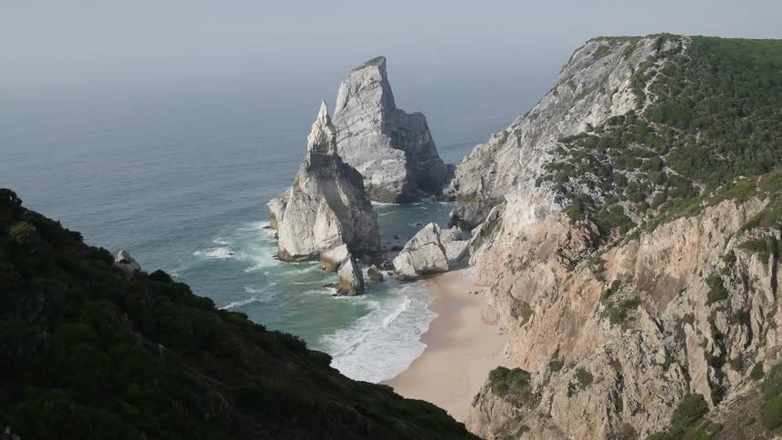 Mountains lead to a beach below