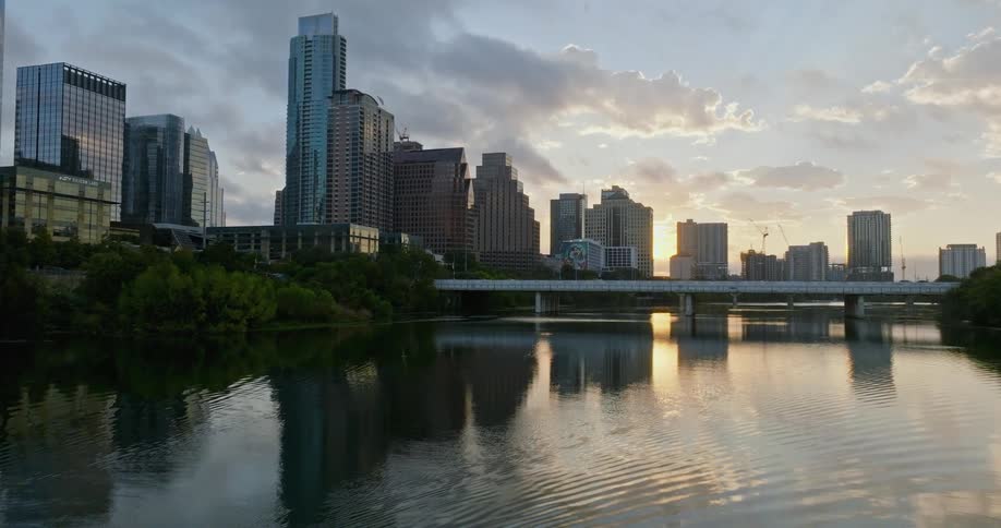 Aerial view of bridges over river and high rise buildings as the sun going down