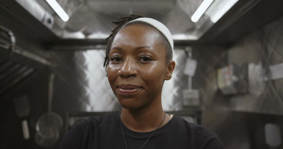 A woman in a restaurant poses for a photo
