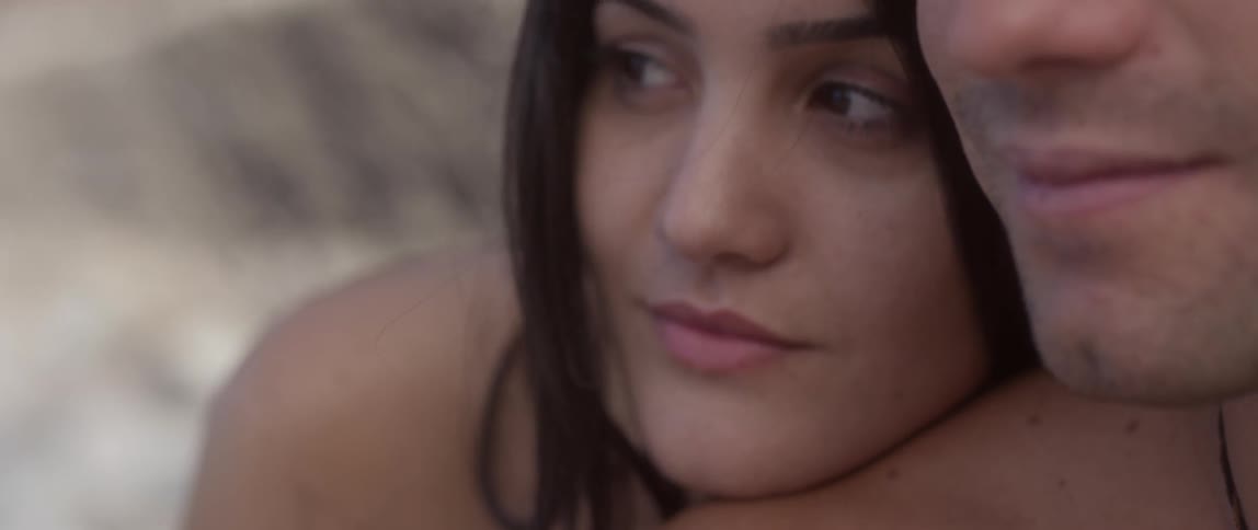 Close-up of a woman resting her head on a man's shoulder
