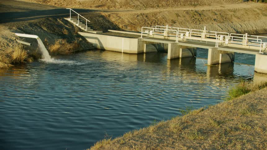 Water flows into an irrigation canal at a diversion dam in the arid US