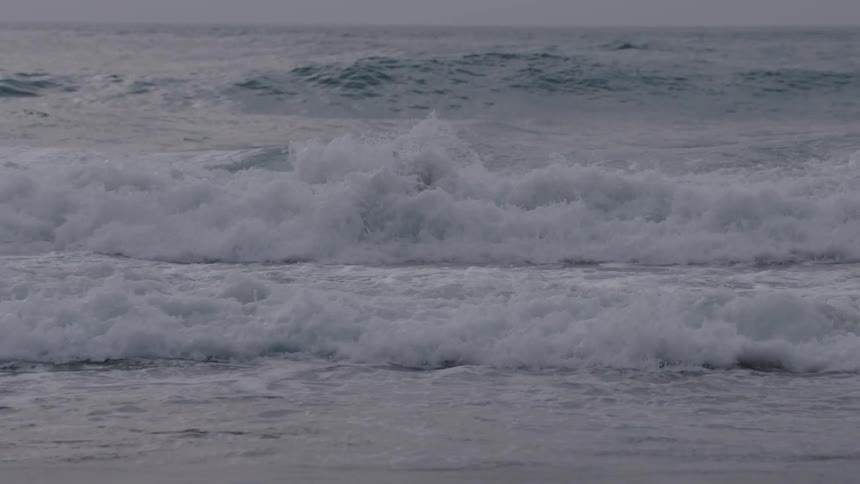Rolling waves coming ashore