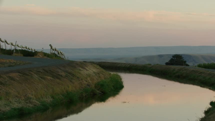 Sunset over an irrigation canal in the rural water starved western united states
