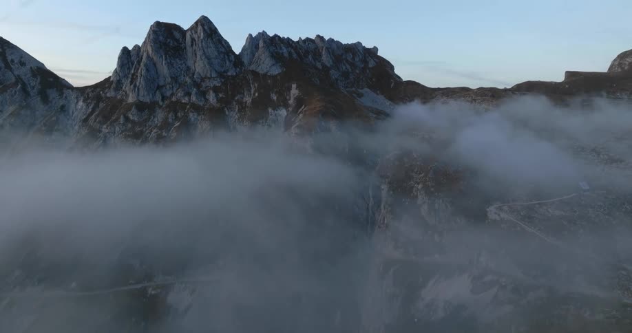 Heavy fog hovers over a mountain range